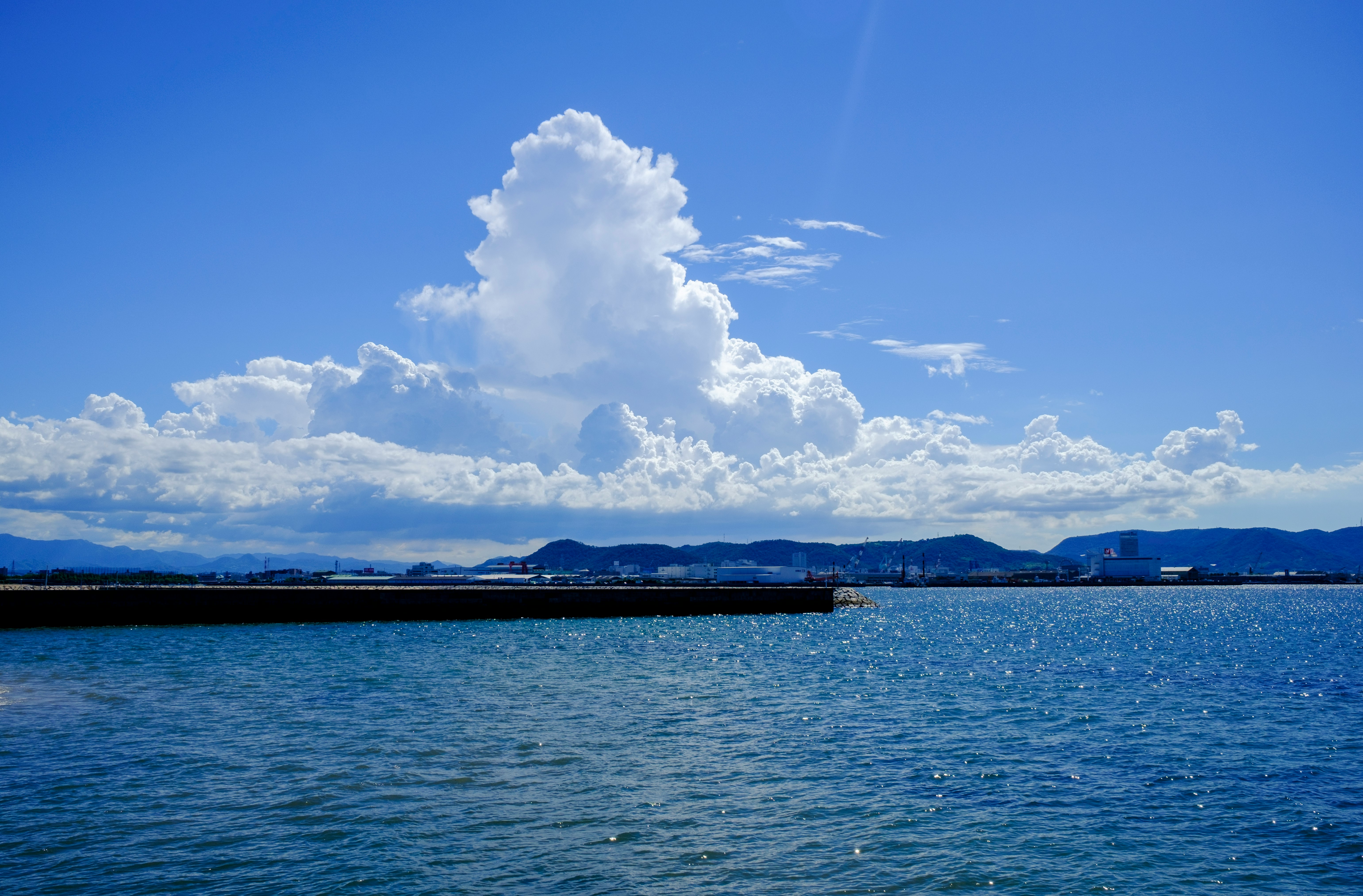 blue sea under blue sky and white clouds during daytime